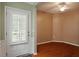 Inviting entryway with hardwood floors, plantation shutters, and a view of the living space at 830 Finnbar Dr, Cary, NC 27519