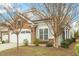 Charming home exterior features a brick and siding facade, a two-car garage, and well-maintained landscaping at 830 Finnbar Dr, Cary, NC 27519