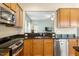 Stainless steel sink and appliances with granite countertops, and dark wood cabinets at 830 Finnbar Dr, Cary, NC 27519