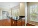 Kitchen island with granite countertop overlooking the breakfast area with natural lighting at 830 Finnbar Dr, Cary, NC 27519