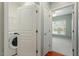 Bright laundry room featuring a Whirlpool washer and dryer, with access to the bedroom at 830 Finnbar Dr, Cary, NC 27519