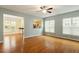 Light-filled living room with hardwood floors and a pass-through to the kitchen, ideal for modern living at 830 Finnbar Dr, Cary, NC 27519
