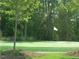 Beautifully maintained putting green surrounded by trees, offering a serene golfing experience at 830 Finnbar Dr, Cary, NC 27519