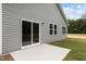 Backyard view of a patio, green siding, and sliding glass doors at 841 Kenyon Spring Dr, Zebulon, NC 27597