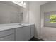 Bathroom featuring a large mirror, white cabinets, and a view of the bedroom at 841 Kenyon Spring Dr, Zebulon, NC 27597