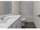 Well-lit bathroom featuring a single sink vanity, toilet, and shower with tub at 841 Kenyon Spring Dr, Zebulon, NC 27597