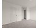 Bedroom featuring neutral walls, plush carpeting, and a view of the hallway at 841 Kenyon Spring Dr, Zebulon, NC 27597