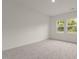 Bright bedroom featuring plush carpeting, neutral walls, and natural light from double windows at 841 Kenyon Spring Dr, Zebulon, NC 27597