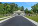 View of a community entrance gate with an asphalt road and landscaping at 841 Kenyon Spring Dr, Zebulon, NC 27597