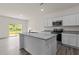 Modern kitchen featuring an island, stainless steel appliances, and granite countertops at 841 Kenyon Spring Dr, Zebulon, NC 27597