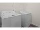 Laundry room with modern, matching washer and dryer and storage shelving at 841 Kenyon Spring Dr, Zebulon, NC 27597