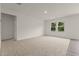 Spacious living room with carpet flooring and two windows for natural light at 841 Kenyon Spring Dr, Zebulon, NC 27597