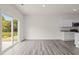 Bright living room with hardwood flooring and a sliding glass door that opens to a pond at 841 Kenyon Spring Dr, Zebulon, NC 27597