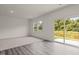 Spacious living room featuring carpet and hardwood floors with a sliding door that opens to a pond at 841 Kenyon Spring Dr, Zebulon, NC 27597