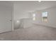 Loft area with plush carpeting, natural light, and staircase at 841 Kenyon Spring Dr, Zebulon, NC 27597