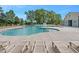 Community pool with surrounding lounge chairs, a fountain, and grass at 841 Kenyon Spring Dr, Zebulon, NC 27597