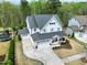 Aerial view of a beautiful two-story home with a spacious driveway and lush green surroundings at 853 Rambling Oaks Ln, Holly Springs, NC 27540