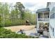 Beautiful backyard featuring a patio with an outdoor kitchen, fire pit, and play set at 853 Rambling Oaks Ln, Holly Springs, NC 27540