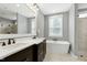 Modern bathroom with double vanity, soaking tub, and glass-enclosed shower at 853 Rambling Oaks Ln, Holly Springs, NC 27540