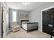 Neutral bedroom features a single bed, carpeted floor, gray walls, and modern decor for a cozy and stylish space at 853 Rambling Oaks Ln, Holly Springs, NC 27540