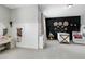 Bedroom features a black accent wall, crib, vanity with mirror, and neutral walls for a soothing aesthetic at 853 Rambling Oaks Ln, Holly Springs, NC 27540
