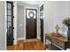 Inviting entryway with hardwood floors and a decorative wreath on the door at 853 Rambling Oaks Ln, Holly Springs, NC 27540