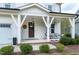 Welcoming front porch with stylish seating and decorative accents at 853 Rambling Oaks Ln, Holly Springs, NC 27540