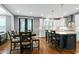 Bright, modern kitchen with white cabinets, stainless appliances, an island with seating, and a breakfast table with chairs at 853 Rambling Oaks Ln, Holly Springs, NC 27540