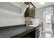Well-lit laundry room featuring gray walls, overhead storage, and modern appliances at 853 Rambling Oaks Ln, Holly Springs, NC 27540