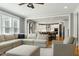 Bright and airy living room seamlessly connects to the kitchen and dining area, perfect for modern living at 853 Rambling Oaks Ln, Holly Springs, NC 27540