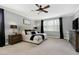 Spacious main bedroom featuring a comfortable bed, matching nightstands, and a large window at 853 Rambling Oaks Ln, Holly Springs, NC 27540