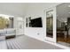 Comfortable screened porch with white wood paneling, a TV and outdoor furniture at 853 Rambling Oaks Ln, Holly Springs, NC 27540