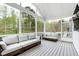 Inviting screened porch with comfortable seating and scenic views of the wooded backyard at 853 Rambling Oaks Ln, Holly Springs, NC 27540