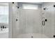 Elegant walk-in shower with glass door and tile surround, creating a spa-like experience at 853 Rambling Oaks Ln, Holly Springs, NC 27540