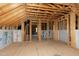 Spacious unfinished attic featuring exposed wooden beams, framed walls and natural light at 853 Rambling Oaks Ln, Holly Springs, NC 27540