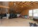 Unfinished attic showcasing wood beams, a window, and spacious storage potential at 853 Rambling Oaks Ln, Holly Springs, NC 27540