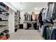 Spacious walk-in closet with custom shelving and ample storage for clothes, shoes, and accessories at 853 Rambling Oaks Ln, Holly Springs, NC 27540