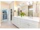 Bright bathroom featuring double vanity, walk-in closet, and a glass-enclosed shower at 9 Hayden Pond Ln, Chapel Hill, NC 27517