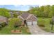 Charming brick home with a two-car garage, mature trees, and landscaped front yard at 9 Hayden Pond Ln, Chapel Hill, NC 27517