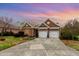 Inviting brick home with two-car garage and well-manicured front lawn, perfect for families at 9 Hayden Pond Ln, Chapel Hill, NC 27517
