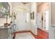 Bright foyer with hardwood floors and a lovely cabinet offers a welcoming entrance to the home at 9 Hayden Pond Ln, Chapel Hill, NC 27517