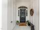 Inviting black front door with glass accents and potted plants offers curb appeal and welcoming entry at 9 Hayden Pond Ln, Chapel Hill, NC 27517