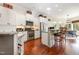 Modern kitchen featuring white cabinets, stainless steel appliances, granite countertops, and hardwood floors at 9 Hayden Pond Ln, Chapel Hill, NC 27517