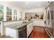 Well-lit kitchen area featuring granite counters, stainless appliances, and hardwood floors in an open layout at 9 Hayden Pond Ln, Chapel Hill, NC 27517