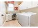 Convenient laundry room with built-in desk, ample storage and modern washer and dryer at 9 Hayden Pond Ln, Chapel Hill, NC 27517