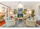 Cozy living room showcasing a fireplace, built-in bookshelves, and comfortable seating arrangement at 9 Hayden Pond Ln, Chapel Hill, NC 27517