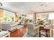 Spacious living room with hardwood floors, ample seating, and seamless flow to the kitchen area at 9 Hayden Pond Ln, Chapel Hill, NC 27517