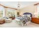 Spacious bedroom features a large window, a comfortable seating area, and a king size bed with luxury bedding at 9 Hayden Pond Ln, Chapel Hill, NC 27517
