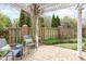 Cozy patio area with a charming pergola, brick columns, and a well-maintained fenced yard at 9 Hayden Pond Ln, Chapel Hill, NC 27517