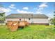 Back view of home with a spacious wood deck, complemented by a well-maintained backyard at 91 Buckingham Ct, Smithfield, NC 27577